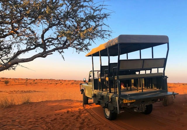 Safari jeep at sunset in the Kalahari Desert, Namibia