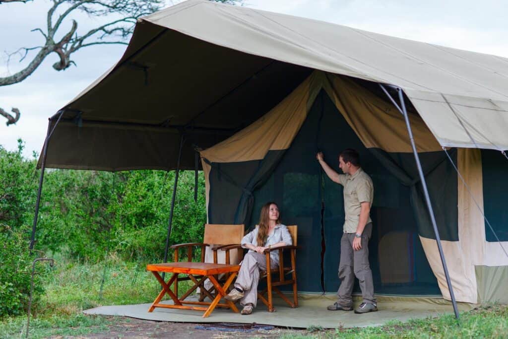 Couple outside safari tent